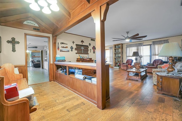 living room featuring ceiling fan, light hardwood / wood-style floors, and lofted ceiling