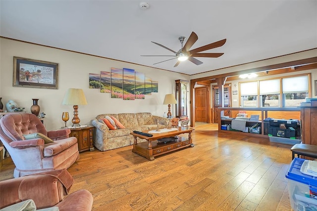 living room with light hardwood / wood-style flooring and ceiling fan