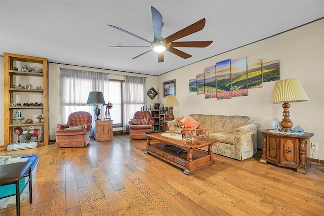 living room featuring ceiling fan and light hardwood / wood-style floors