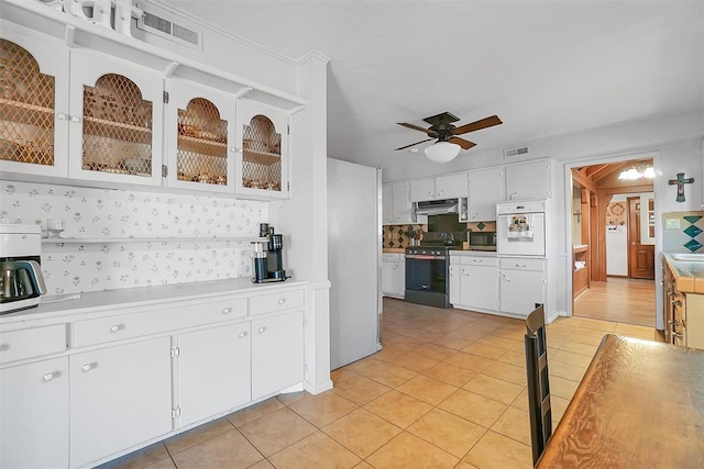 kitchen with white cabinets, oven, electric range, ceiling fan, and light tile patterned floors