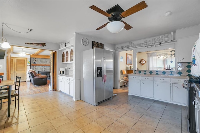 kitchen featuring white cabinetry, ceiling fan, stainless steel appliances, and light tile patterned floors