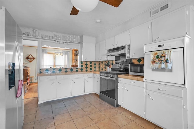 kitchen with white cabinetry, ceiling fan, and appliances with stainless steel finishes