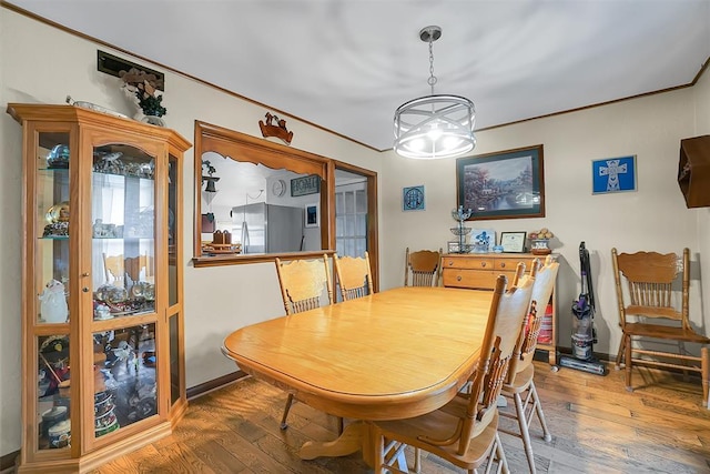 dining room with wood-type flooring and a chandelier