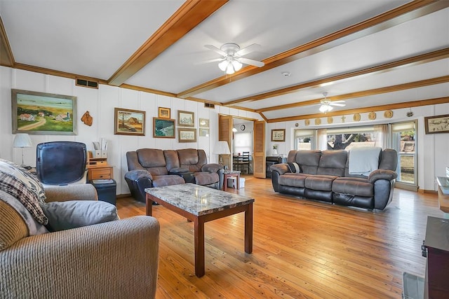 living room with ceiling fan, beamed ceiling, and light wood-type flooring