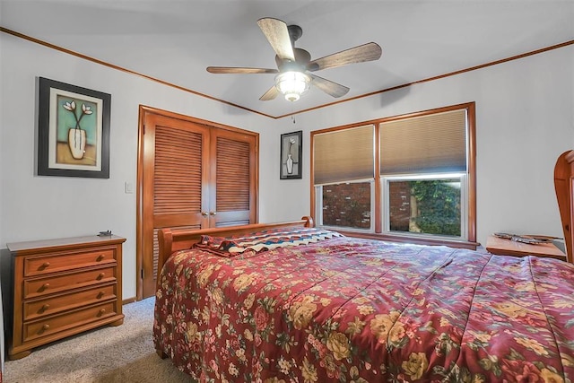 carpeted bedroom featuring ceiling fan and ornamental molding