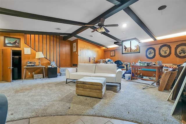 living room featuring tile patterned flooring, vaulted ceiling with beams, ceiling fan, and wooden walls