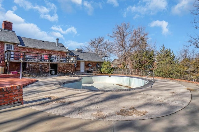 view of pool with a patio area and a wooden deck