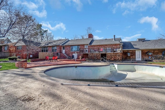 view of pool with a patio area and a deck