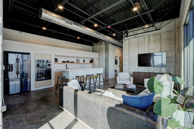 living room featuring concrete flooring