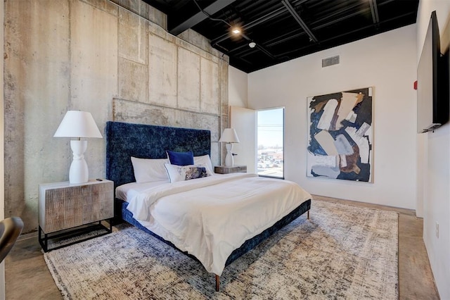 bedroom featuring a towering ceiling