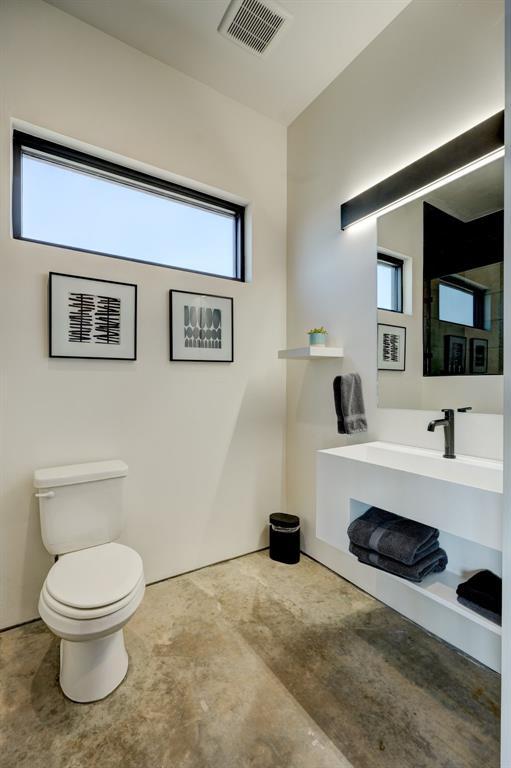 bathroom with toilet and plenty of natural light