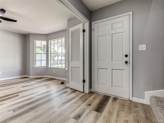 entryway with ceiling fan and light wood-type flooring