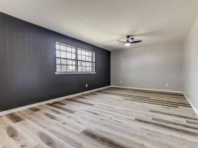 empty room featuring ceiling fan and light wood-type flooring