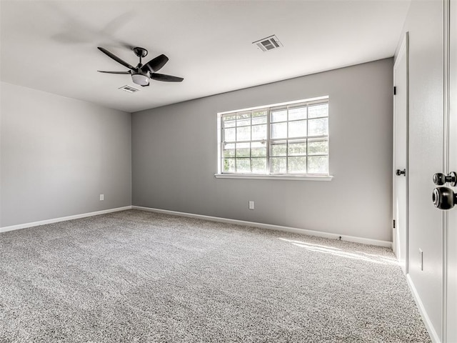 carpeted spare room with ceiling fan