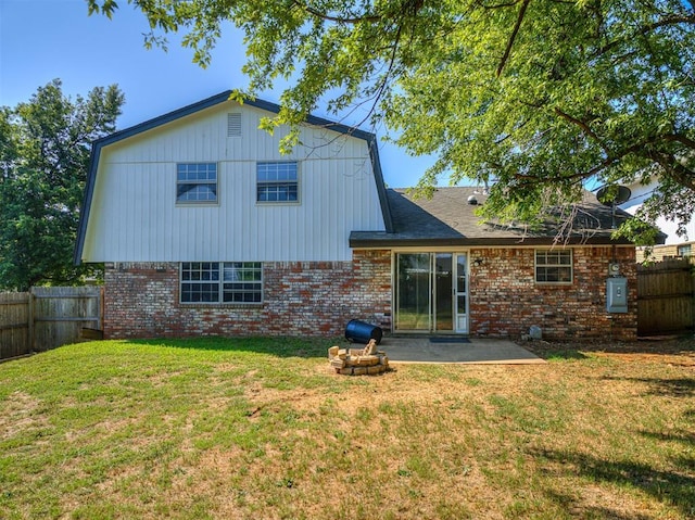 rear view of house featuring a lawn and a patio