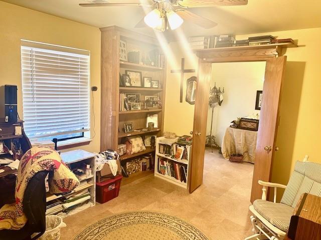 interior space with ceiling fan