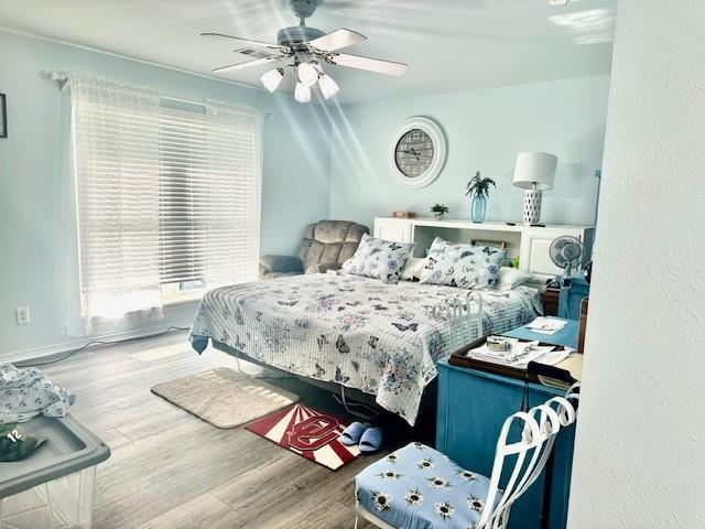 bedroom featuring ceiling fan and wood-type flooring