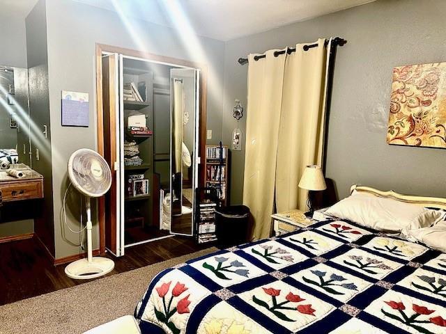 bedroom featuring dark hardwood / wood-style floors and a closet