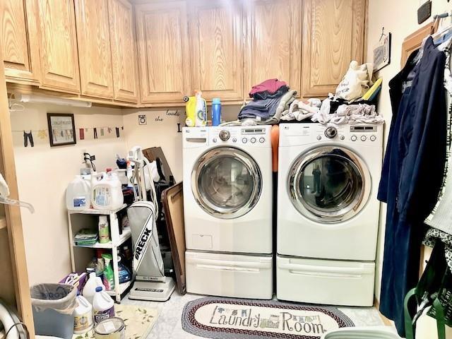 laundry area featuring cabinets and washing machine and dryer