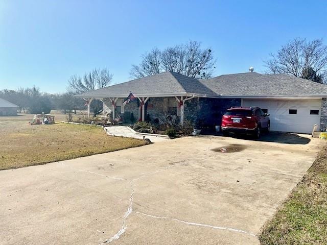 ranch-style house featuring a garage and a front lawn