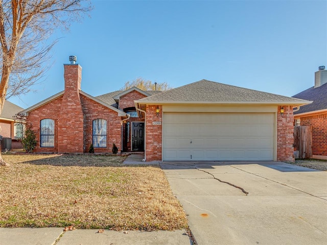 ranch-style home featuring cooling unit, a front yard, and a garage