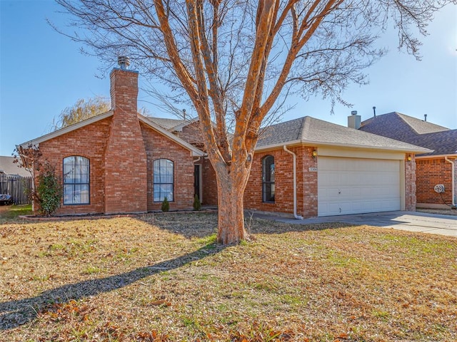 single story home featuring a garage and a front lawn