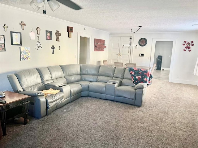 carpeted living room featuring ceiling fan, crown molding, and a textured ceiling