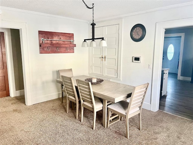 carpeted dining area featuring a textured ceiling and crown molding