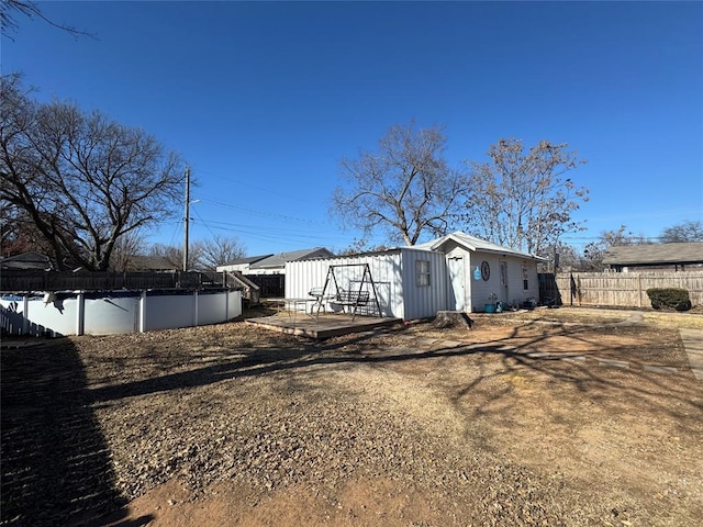 view of property exterior with a swimming pool side deck