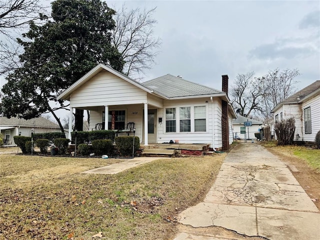 bungalow-style house featuring a front lawn