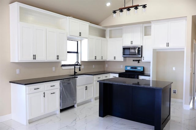 kitchen with a center island, white cabinets, stainless steel appliances, and sink