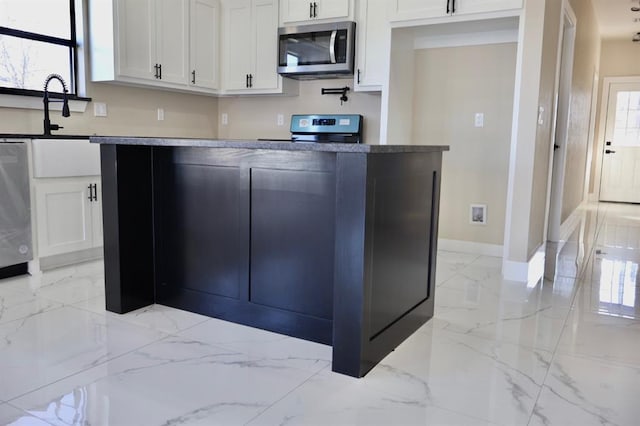 kitchen with appliances with stainless steel finishes and white cabinetry