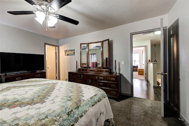 bedroom featuring a ceiling fan, carpet, and baseboards