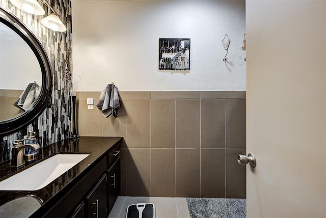 bathroom featuring tile walls and vanity