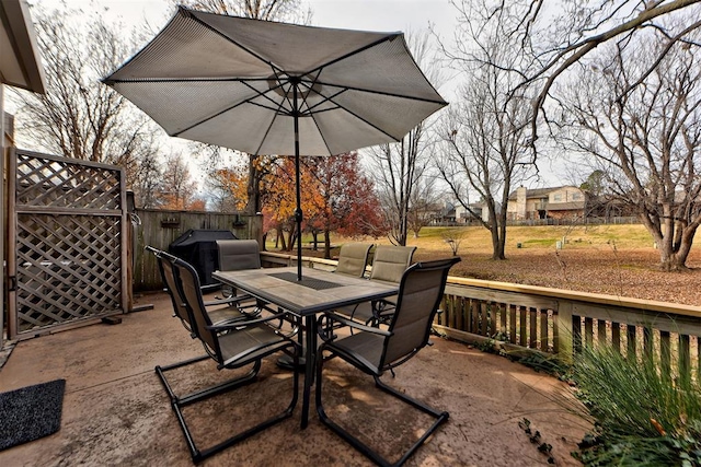 view of patio with outdoor dining space and a grill