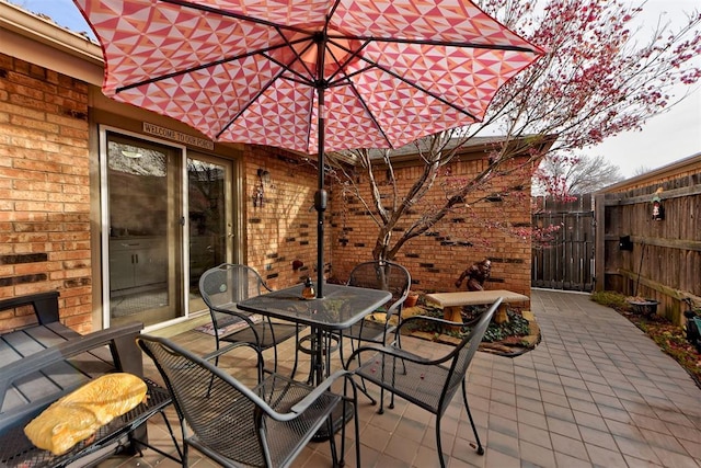 view of patio / terrace featuring fence and outdoor dining area