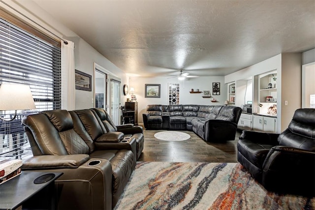 living room featuring a textured ceiling, a ceiling fan, and wood finished floors