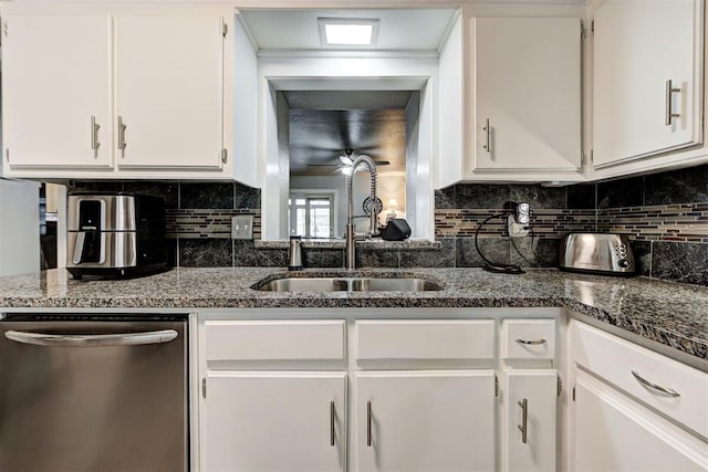 kitchen with tasteful backsplash, white cabinets, a sink, dark stone counters, and dishwasher