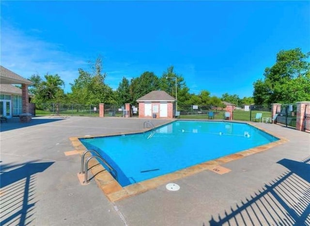 pool featuring a patio area and fence