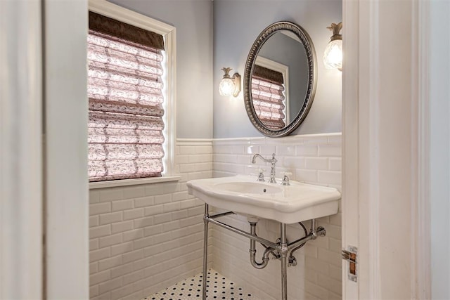 bathroom featuring tile walls and wainscoting