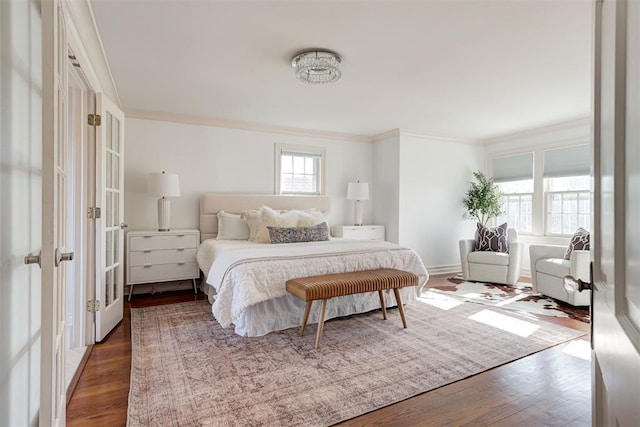 bedroom with ornamental molding, baseboards, and dark wood-style flooring