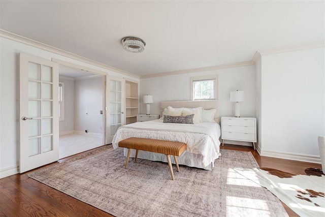 bedroom featuring french doors, crown molding, and wood finished floors