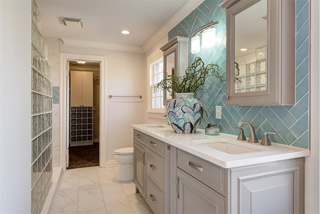 full bathroom featuring tasteful backsplash, visible vents, double vanity, marble finish floor, and a sink