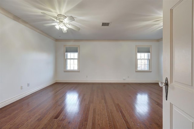 spare room featuring visible vents, a ceiling fan, hardwood / wood-style floors, and crown molding