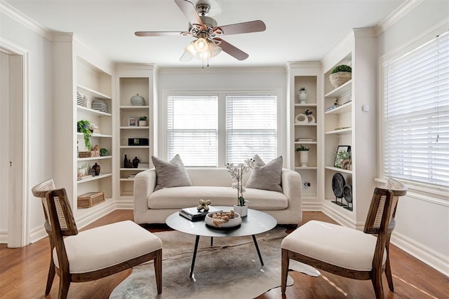 sitting room featuring crown molding, wood finished floors, and baseboards