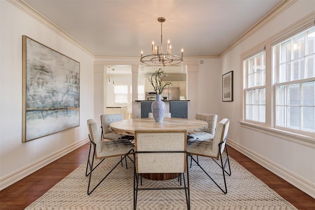 dining space featuring crown molding, a notable chandelier, baseboards, and dark wood-style flooring