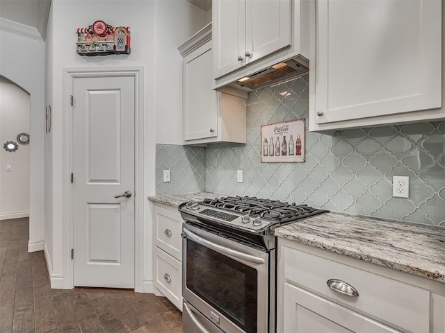 kitchen with dark wood-type flooring, decorative backsplash, light stone countertops, gas stove, and white cabinetry