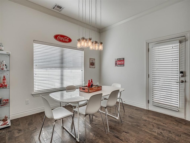 dining room featuring crown molding and dark wood-type flooring