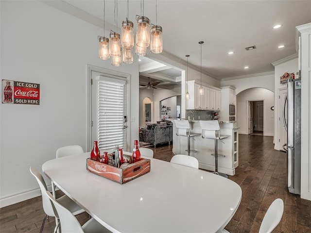 dining area with beamed ceiling, ceiling fan, dark hardwood / wood-style floors, and coffered ceiling