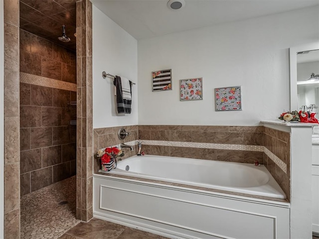 bathroom featuring shower with separate bathtub